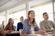 © Drazen - Group of happy college students listening lecture in the classroom.
