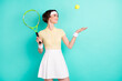 © deagreez - Photo of nice happy cheerful young woman look fall catch ball racket sportswoman isolated on teal color background
