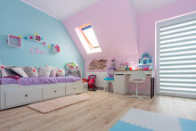 Turquoise And Pink Childrens Room With A Study Desk And Toys.