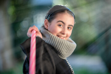 Wall Mural - Smiling young girl outdoor holding hula hoop