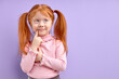 © alfa27 - Pretty child girl with natural red hair stand thinking isolated on purple background touching chin looking aside smiling