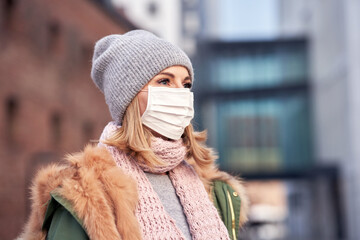 Woman wearing face mask because of Air pollution or virus epidemic in the city