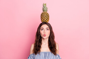 Photo of pretty cute lady wear off-shoulders clothes holding head pineapple looking empty space isolated pink color background