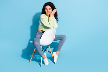 Poster - Full body portrait of adorable satisfied lady sit folded arms palms on cheek look camera isolated on blue color background