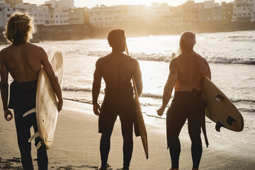 Wall Mural - Multi generational surfer men having fun on the beach - Multiracial people, lifestyle and sport concept - Focus on senior head