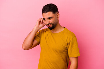 Young mixed race man isolated on pink background