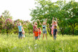 © Andrey - A group of happy children of boys and girls run in the Park on the grass on a Sunny summer day . The concept of ethnic friendship, peace, kindness, childhood