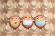 Creative Easter eggs with Corona virus (COVID19) protection concepts. Diverse chicken eggs with doodle faces wearing medical masks.
