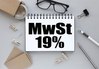 MwST 19%. text on white paper on gray background