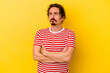 © Asier - Young caucasian man isolated on yellow background tired of a repetitive task.