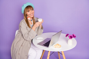 Sticker - Photo of girl sit table pc drink coffee use toothy smile wear blue beret coat isolated violet color background