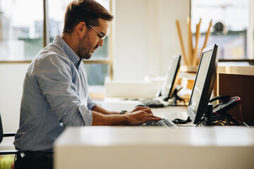 freelancer working on computer in office