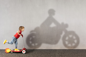 Wall Mural - Happy kid dreams about bike. Imagination, freedom and motivation concept