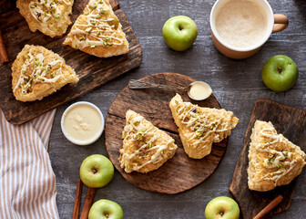 Sticker - scones with apple, pistachios and white chocolate on a wooden background.