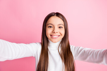 Photo of charming funny young girl wear white jumper smiling tacking selfie isolated pink color background