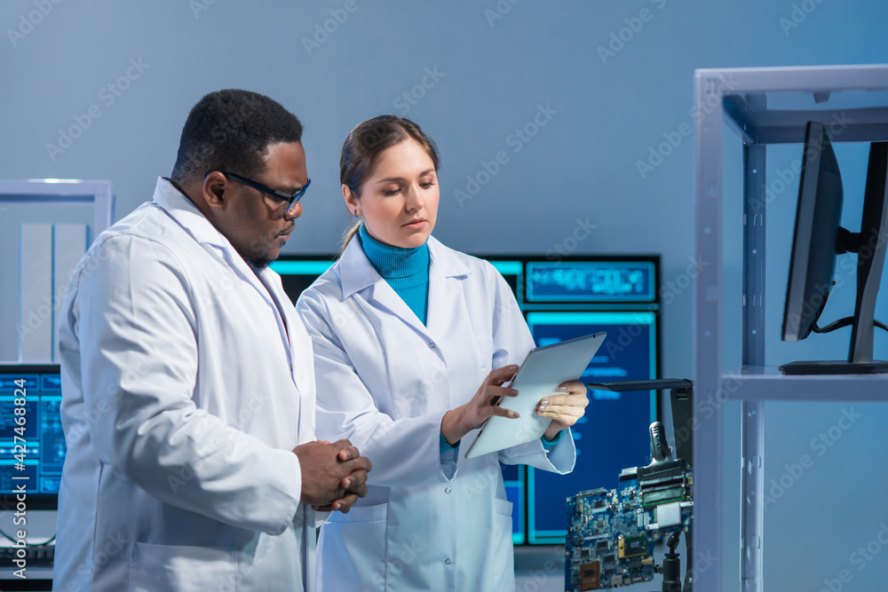 Diverse team of microelectronic engineers discuss current developments ...