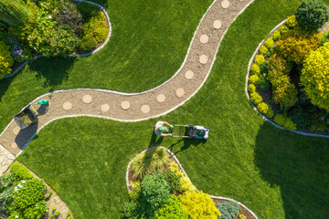 big garden grass field mowing by caucasian gardener