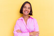 © Asier - Young mixed race woman isolated on yellow background who feels confident, crossing arms with determination.
