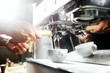 © romandatso - Bartender making coffee barista in a cafe