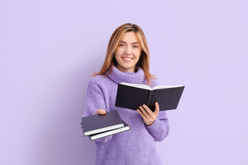 Canvas Print - Woman with books on color background