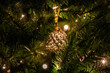 Selective focus shot of a Christmas tree ball and lights