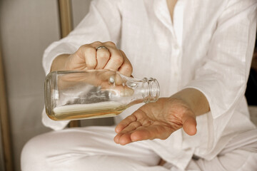 Poster - Closeup shot of a female using a body oil for spa