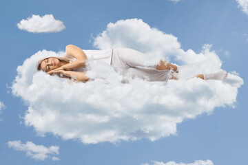 Sticker - Young woman in pajamas sleeping on clouds