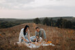 © Anne Ponomarenko - young happy family outdoors. family picnic on the hill in the forest. a young family is having dinner on the mountain. copy space on top