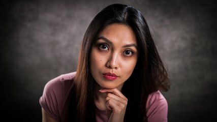 Young pretty woman with thoughtful facial expression - studio photography