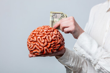 Wall Mural - Portrait of beautiful blonde in white shirt with human brain on white background