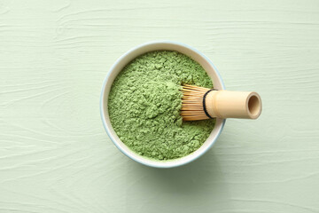 Wall Mural - Bowl with powdered matcha tea and chasen on color wooden background