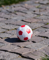 A football ball dropped in the backyard. Toys for boys who want to play.