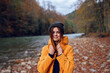 © SHOTPRIME STUDIO - woman walks in the autumn forest in a yellow jacket mountains travel