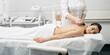 © Peakstock - Gouache massage. Doctor doing a physical effect on woman's body using a gouache scraper for increased blood and lymph flow