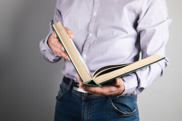 Wall Mural - man standing holding a book