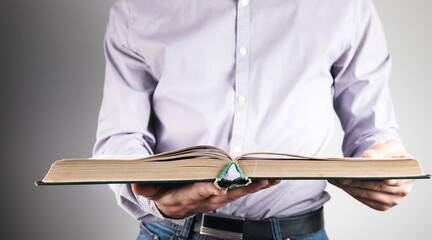 Wall Mural - man standing holding a book