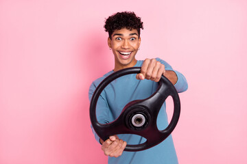 Wall Mural - Photo of young excited black man happy positive smile steering-wheel drive auto isolated over pink color background