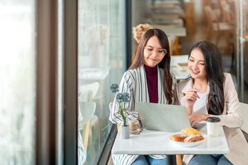 Wall Mural - asian female creative agency casual meeting discussion working with laptop coffee work from home with client co worker,asian young woman with window and water rain drop raining background