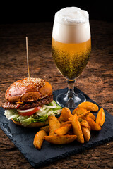 Sticker - Set of hamburger beer and french fries. A standard set of drinks and food in the pub, beer and snacks. Dark background, fast food.