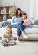 © Syda Productions - people, family and technology concept - happy mother and two daughters with smartphone at home
