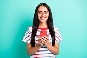 Poster - Photo of charming positive young lady hold smartphone good mood smile isolated on pastel teal color background