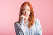 © Павел Костенко - Portrait of a redhead pensive girl in the studio on a pink background