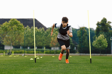 Teenage Athlete on Running Training Speed Tests. Young Boy Running Fast in Cleats and Soccer Sports Uniform. Football Practice Unit