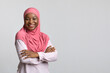 © Prostock-studio - Smiling black lady in hijab posing on grey