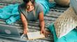 © simona - Young woman at home laying on the floor studying with laptop computer and book - happy lifestyle female people realx and work with internet - novel reading and enjoyment time