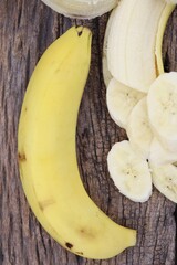 Canvas Print - Banana tropical fruit slices on brown background or texture