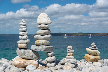 Wall Mural - Pile of stones on a beach, ocean background in Brittany, France