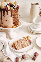 Poster - Slice of a yummy chocolate and berry cake on a plate next to the whole cake