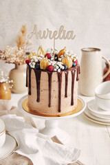 Sticker - Lovely chocolate cake with fruity topping celebrating the birthday of a woman named 