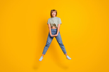 Poster - Full length body size view of charming cute modest cheerful girl jumping having fun isolated over bright yellow color background